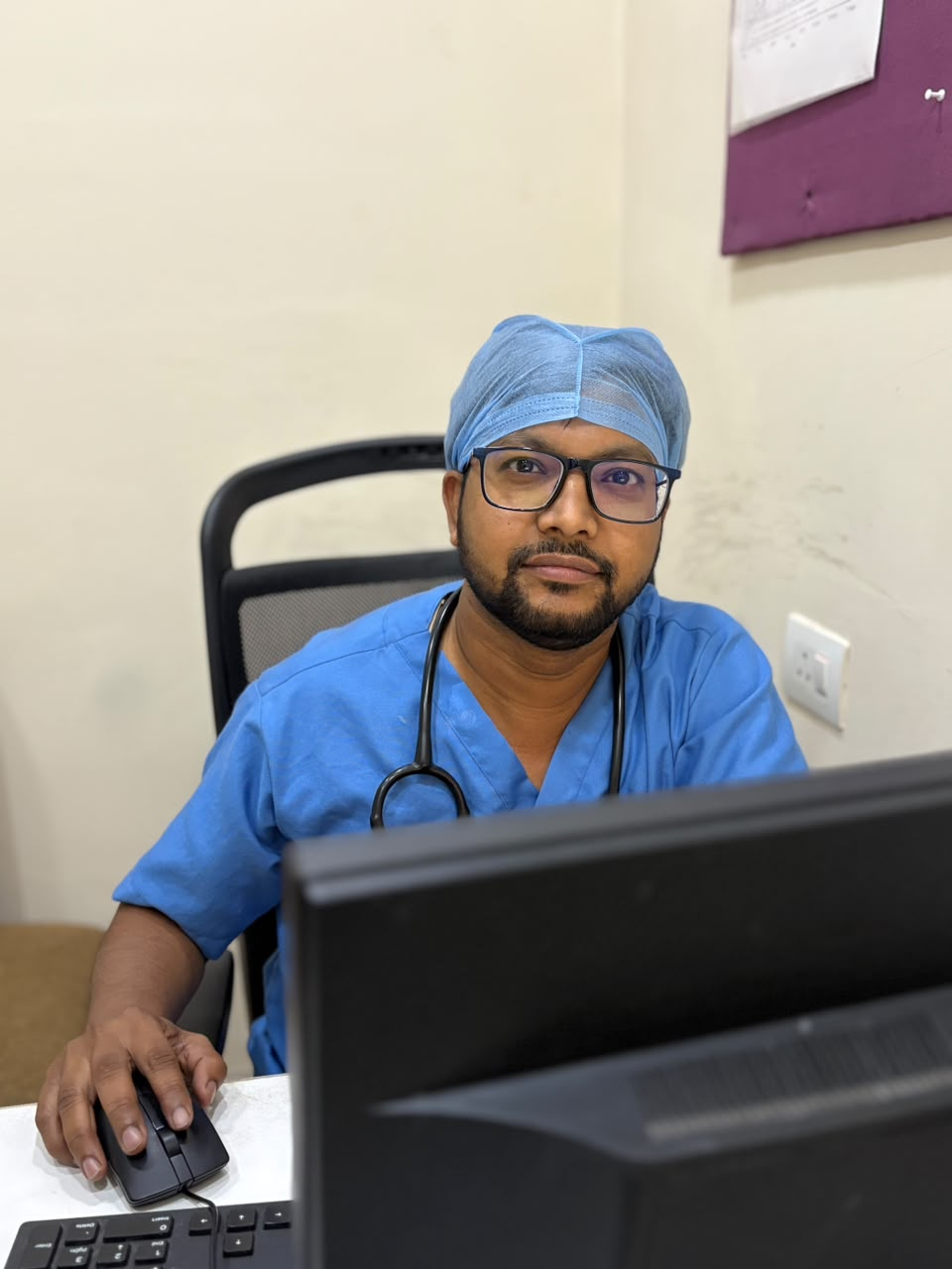Dr. Vishwanath reviewing patient records at his clinic desk in Sector 16 Rohini