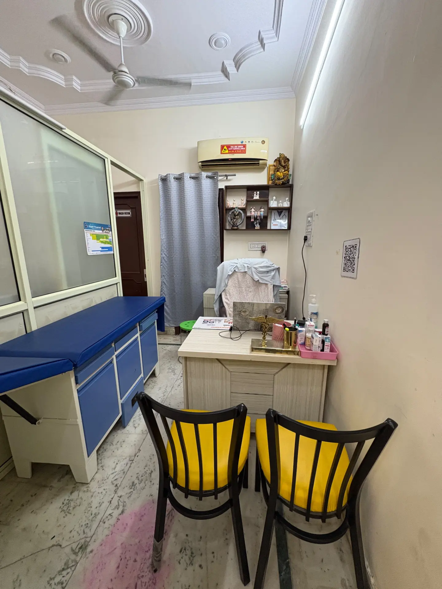 Consultation room with examination couch and doctor's desk inside Wellnest Child Care Centre