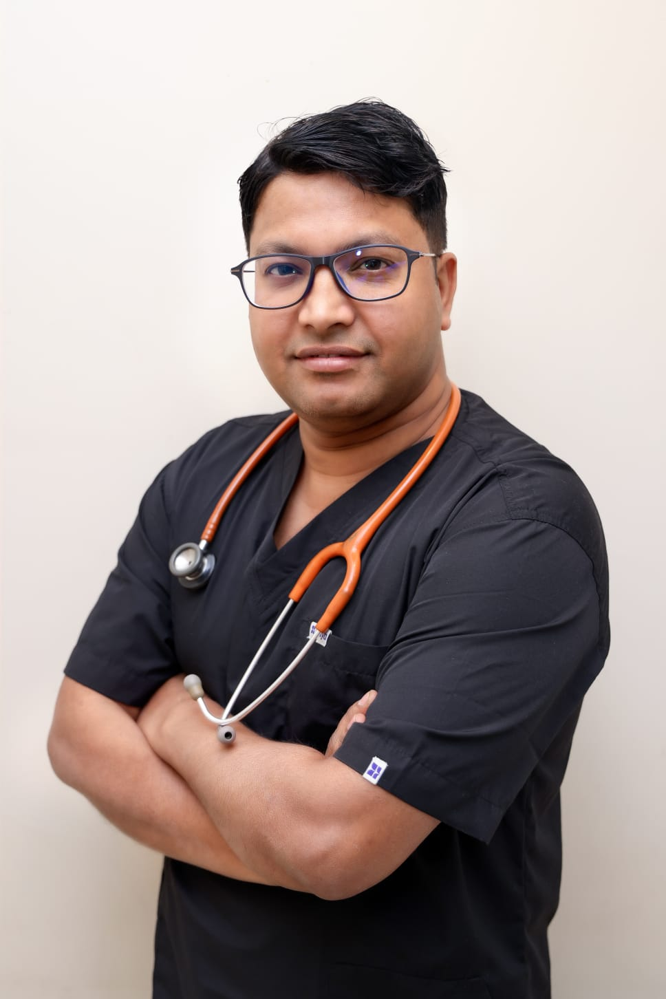 Dr. Vishwanath in black scrubs with stethoscope, child specialist at Wellnest Rohini